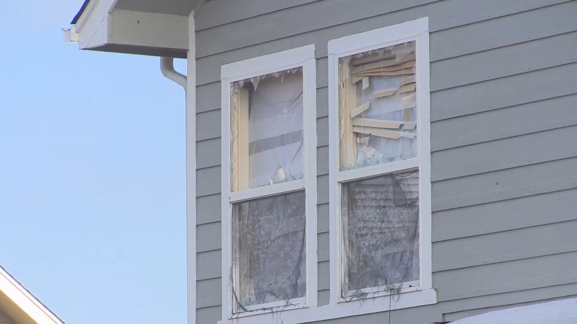 cracked window pane and torn window screens on a westminster colorado home caused by hail
